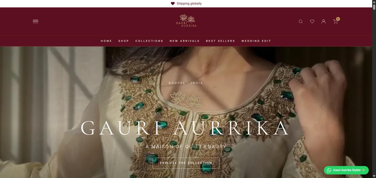 The Gauri Aurrika shop homepage: a full-width photograph of gold and emerald embroidery, with the brand name and an invitation to explore the collection over it.